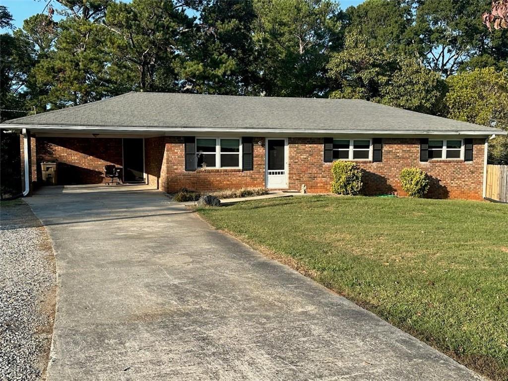 a front view of a house with a yard and trees