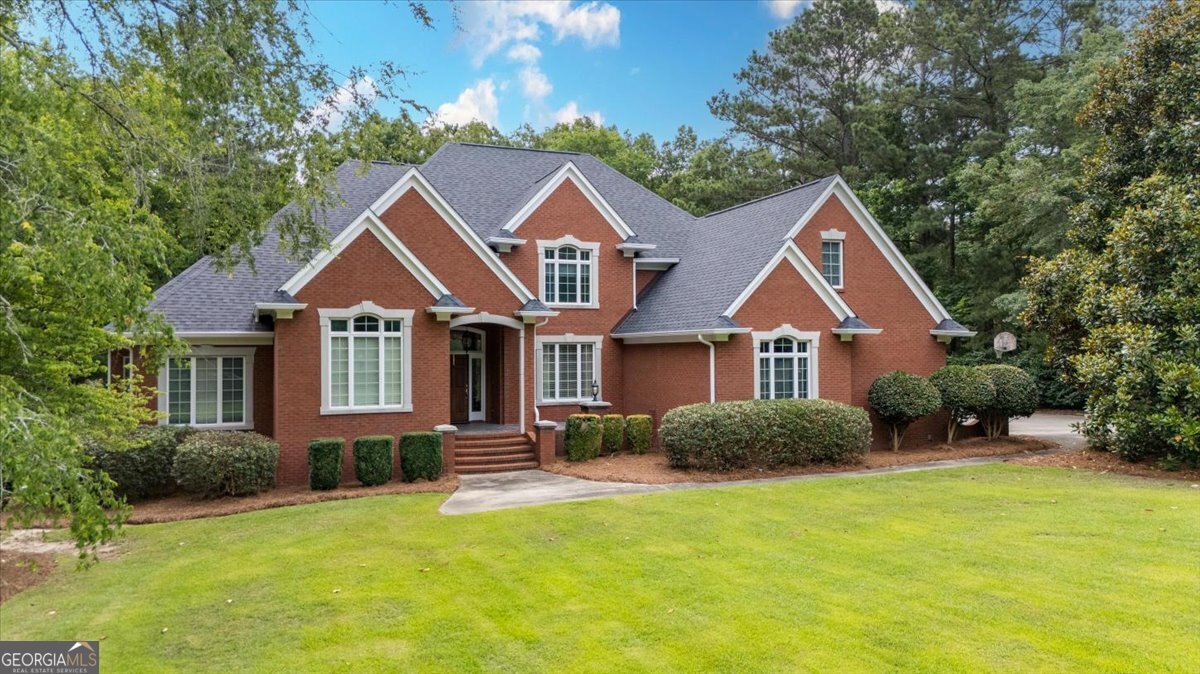 a front view of a house with a yard and garage