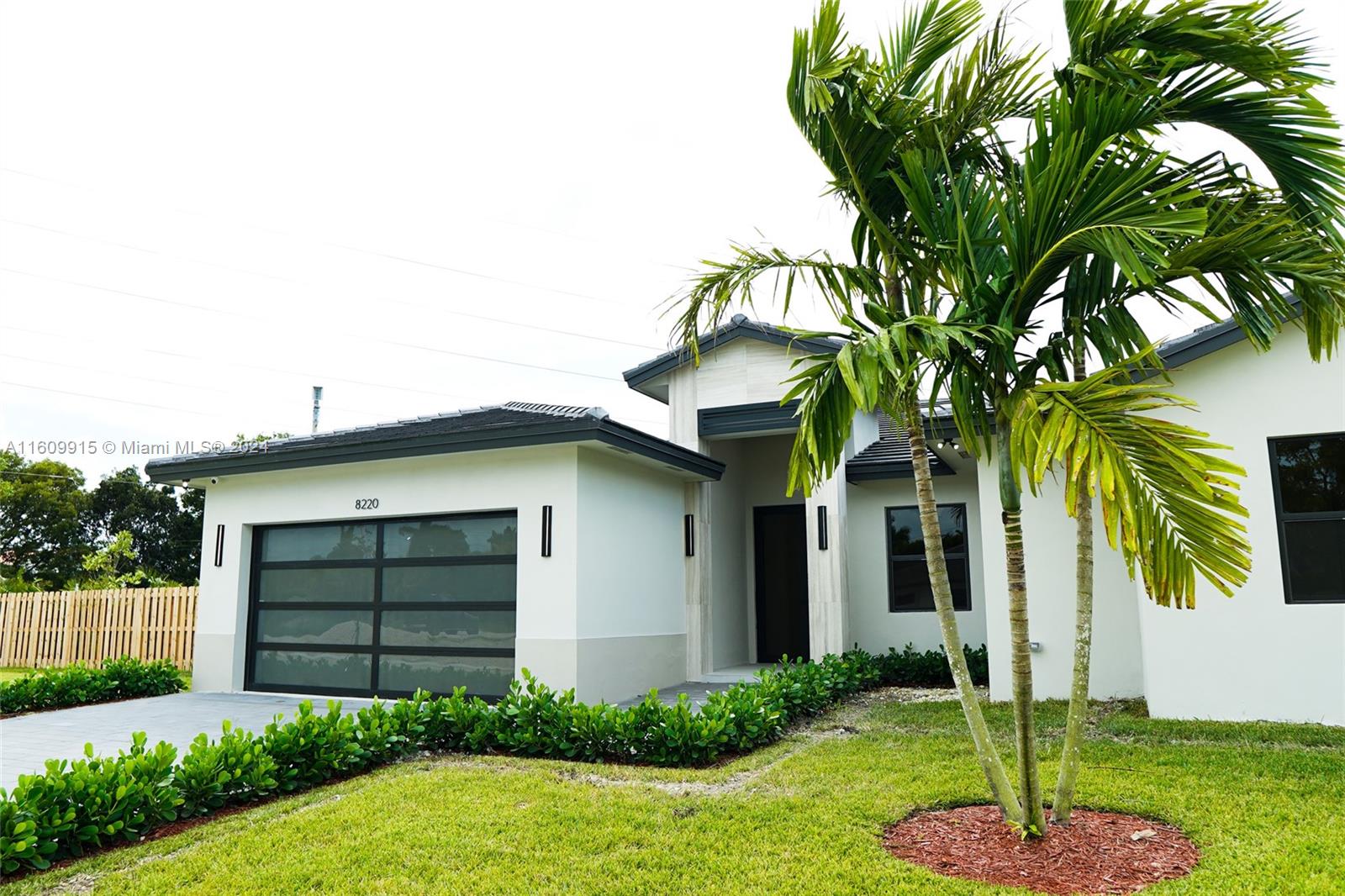 a house that has a tree in front of the house