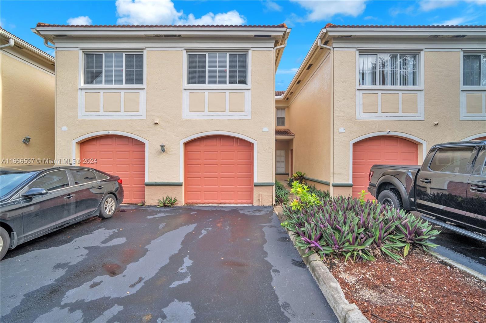 a couple of cars parked in front of a house