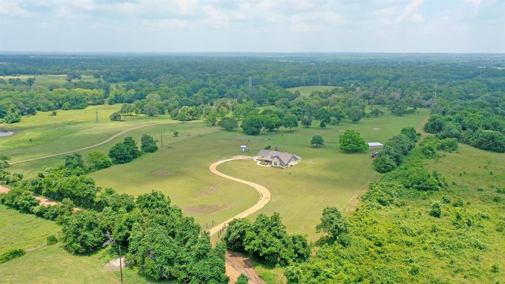 an aerial view of a house with a yard