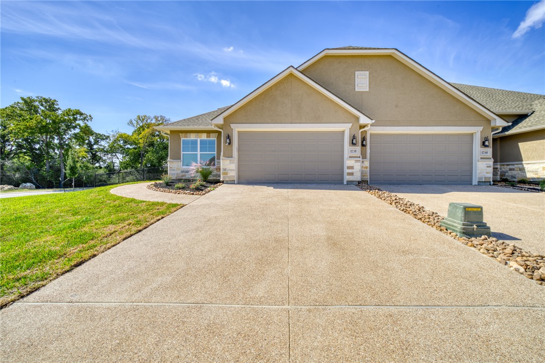 View of front of property with a front yard and a