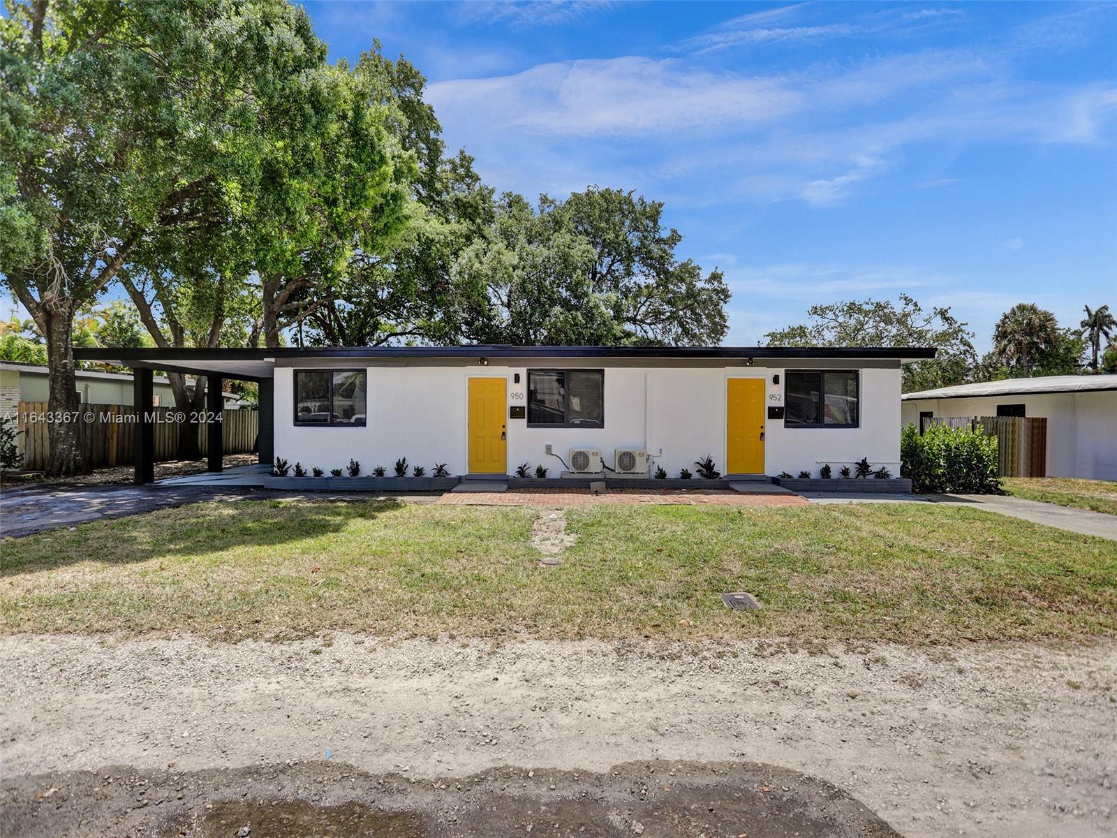 a view of a house with backyard and a tree