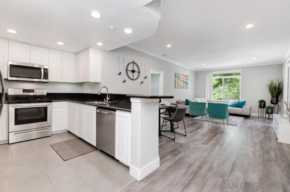 a kitchen with a sink cabinets and wooden floor