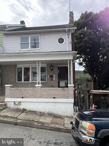 front view of a house with a car parked in front of it