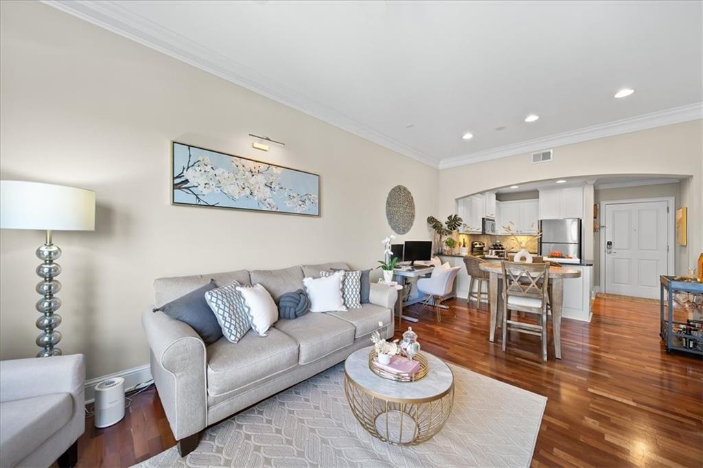 a living room with furniture kitchen view and a table