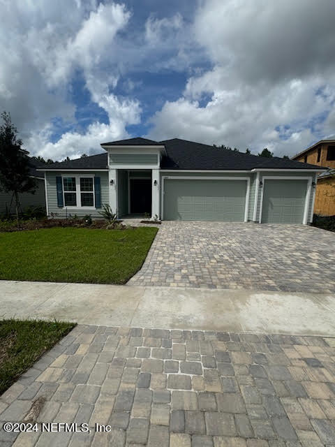 a front view of house with yard and green space