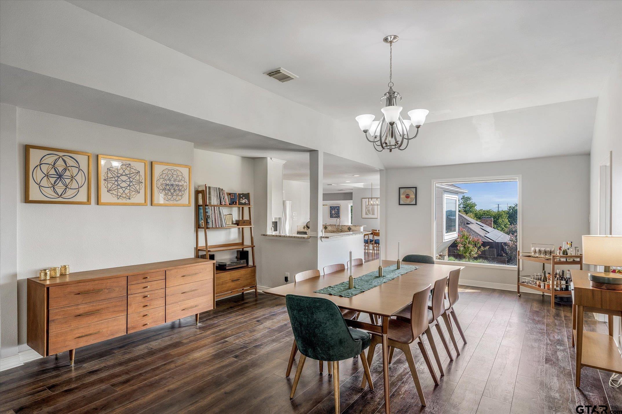 a view of a dining room with furniture wooden floor and chandelier