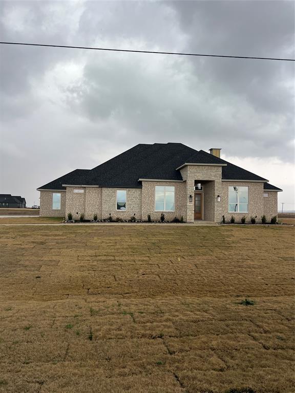 a view of a big house with a big yard