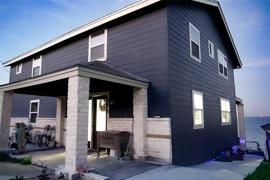 a front view of a house with outdoor seating