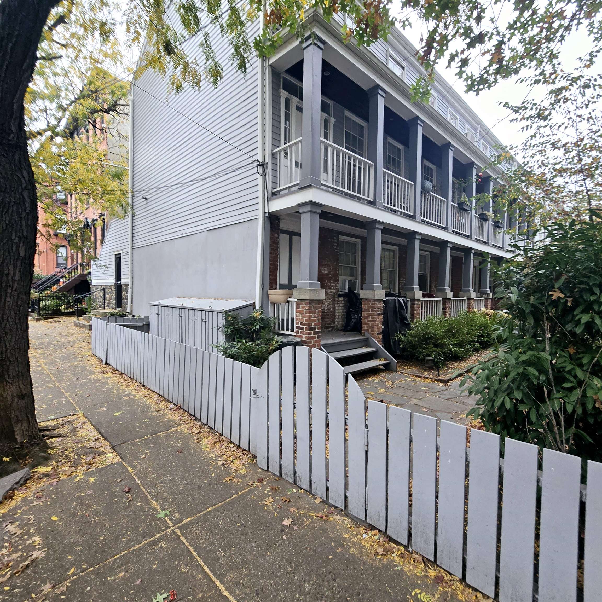 a front view of a house with wooden fence