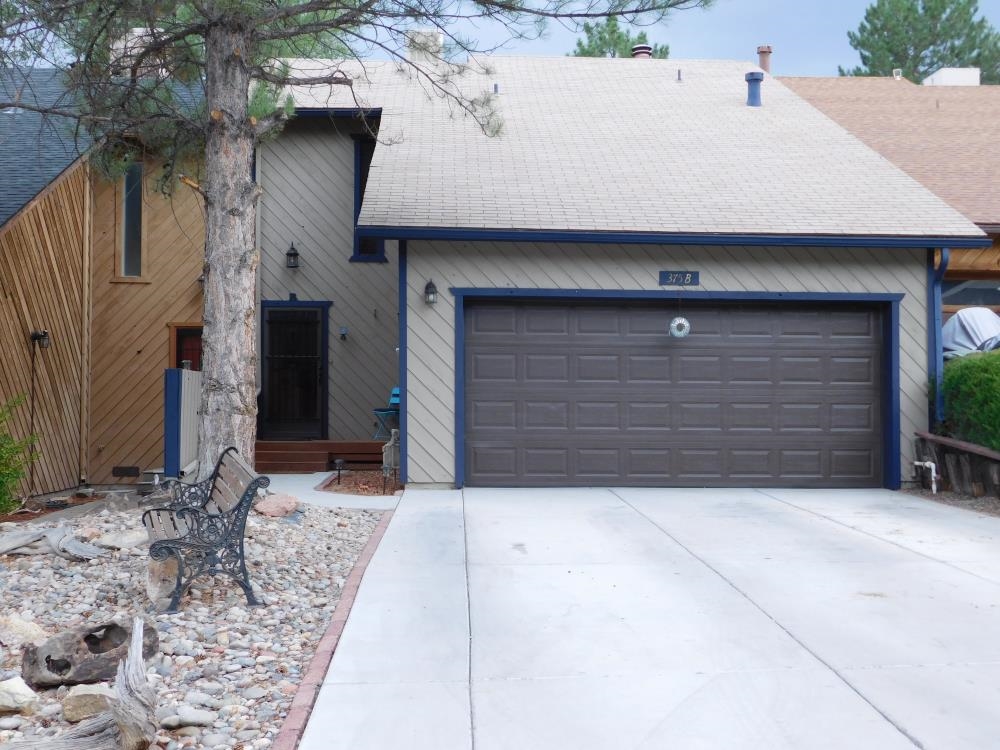 a front view of a house with garage