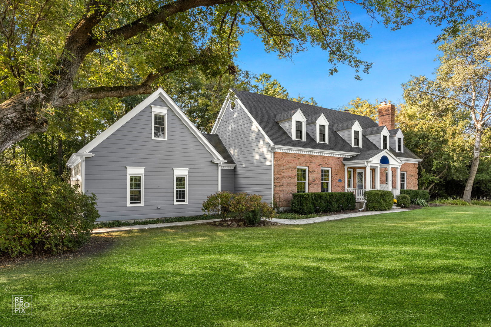 a front view of house with yard and green space