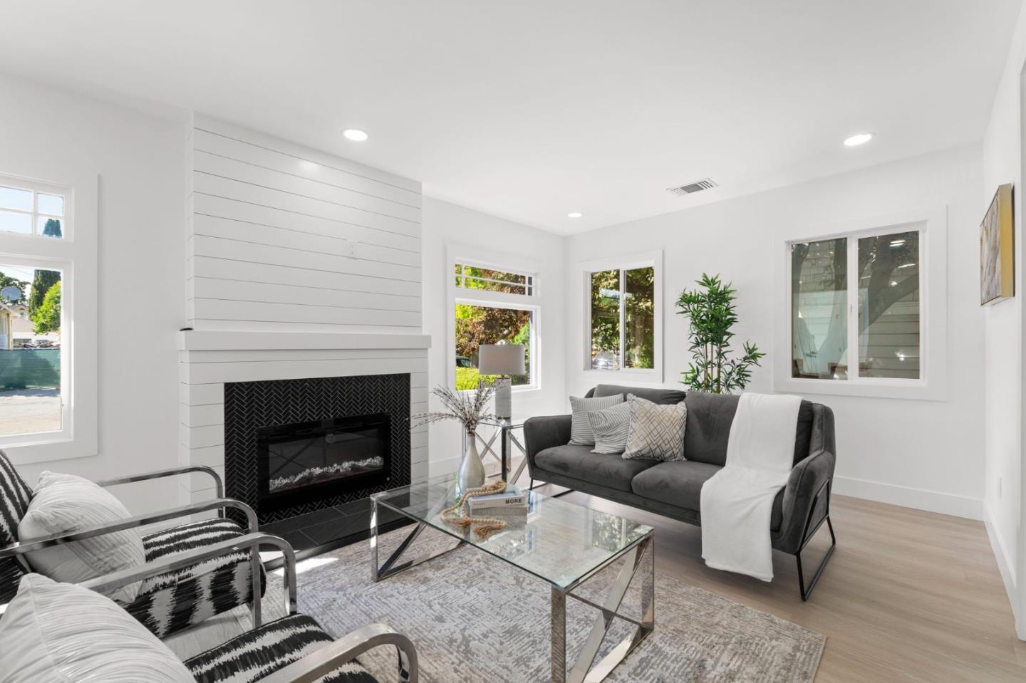 a living room with furniture and a fireplace