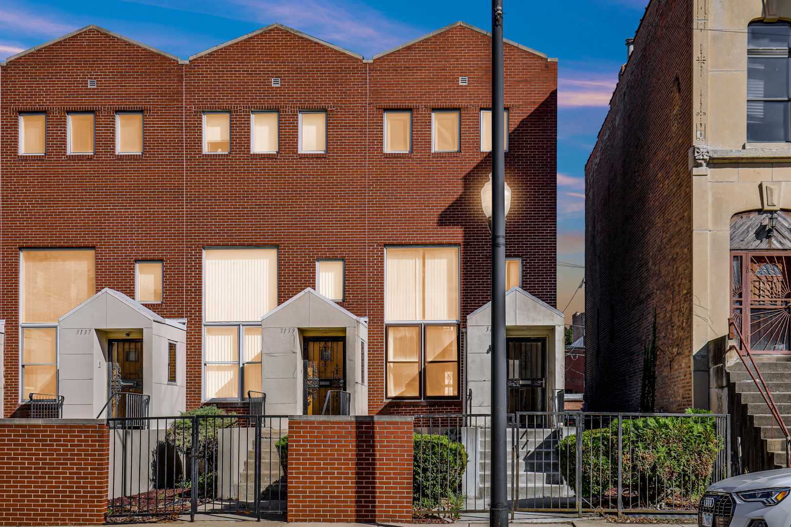 a front view of a brick house with a yard