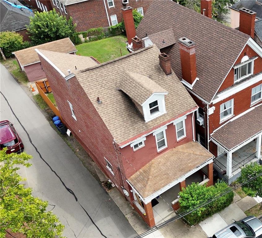 an aerial view of a house with a yard