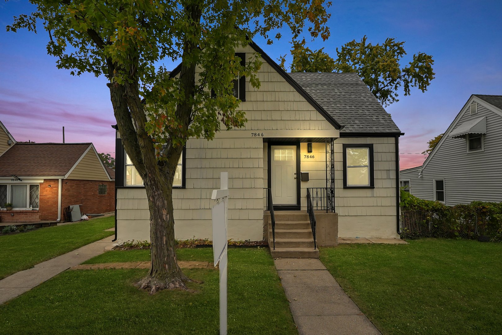 a front view of a house with a garden