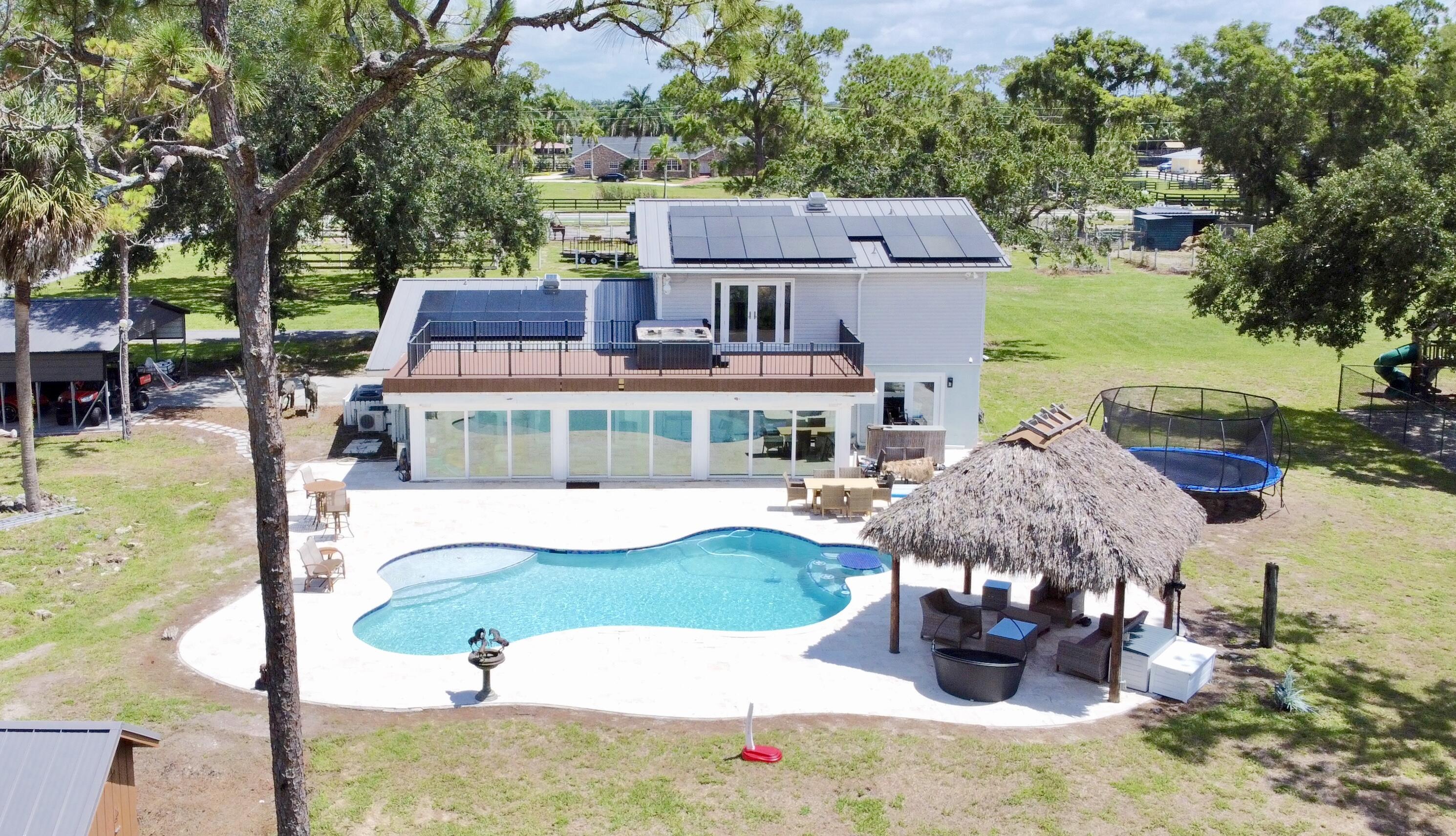 a aerial view of a house with swimming pool garden and patio