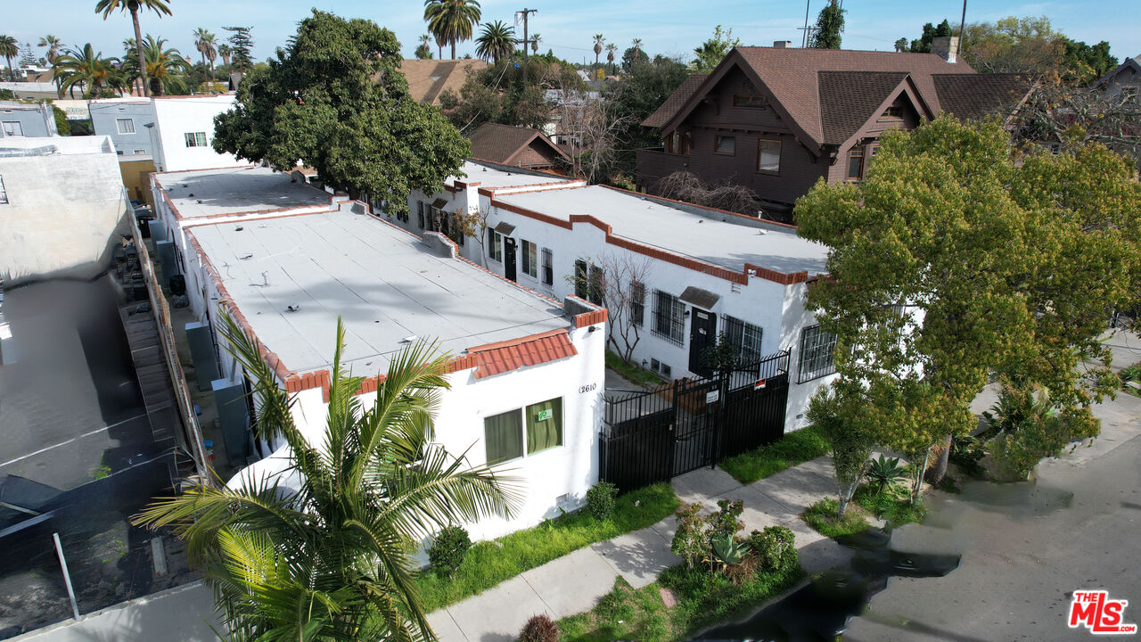 a aerial view of a house with a yard and potted plants