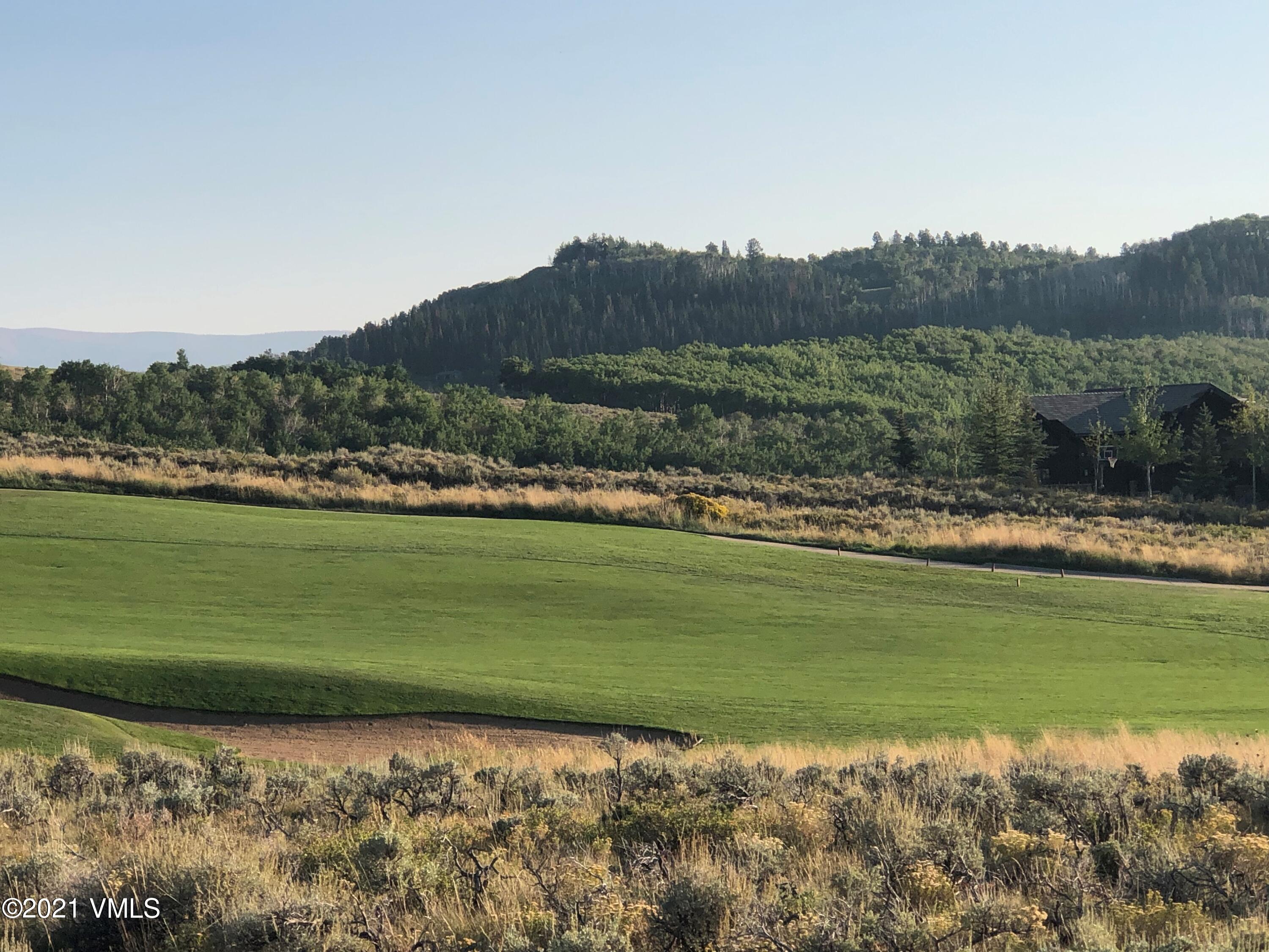 a view of a golf course with a lake