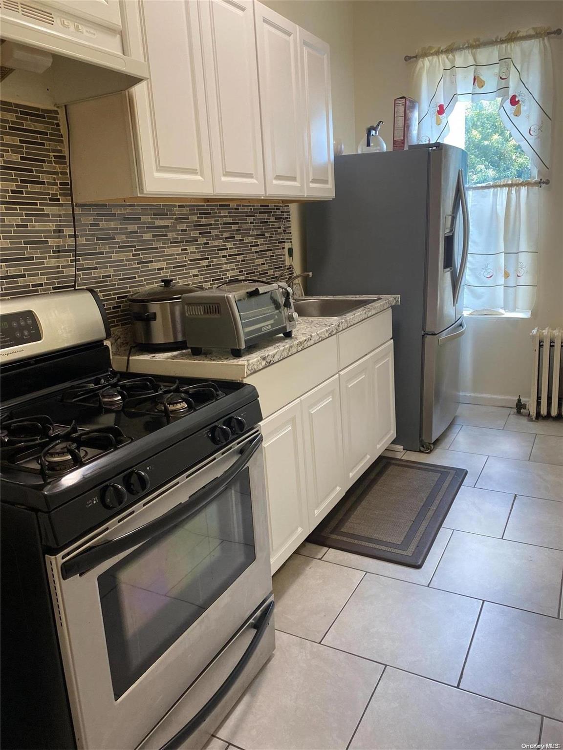 a kitchen with a stove and a refrigerator