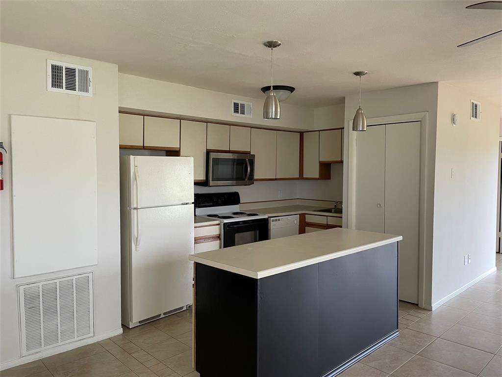 a kitchen with stainless steel appliances a refrigerator and a stove