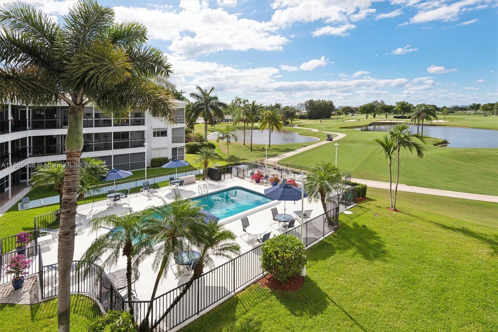 a view of a swimming pool and lounge chairs