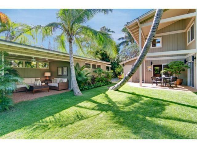 a view of a house with backyard porch and sitting area