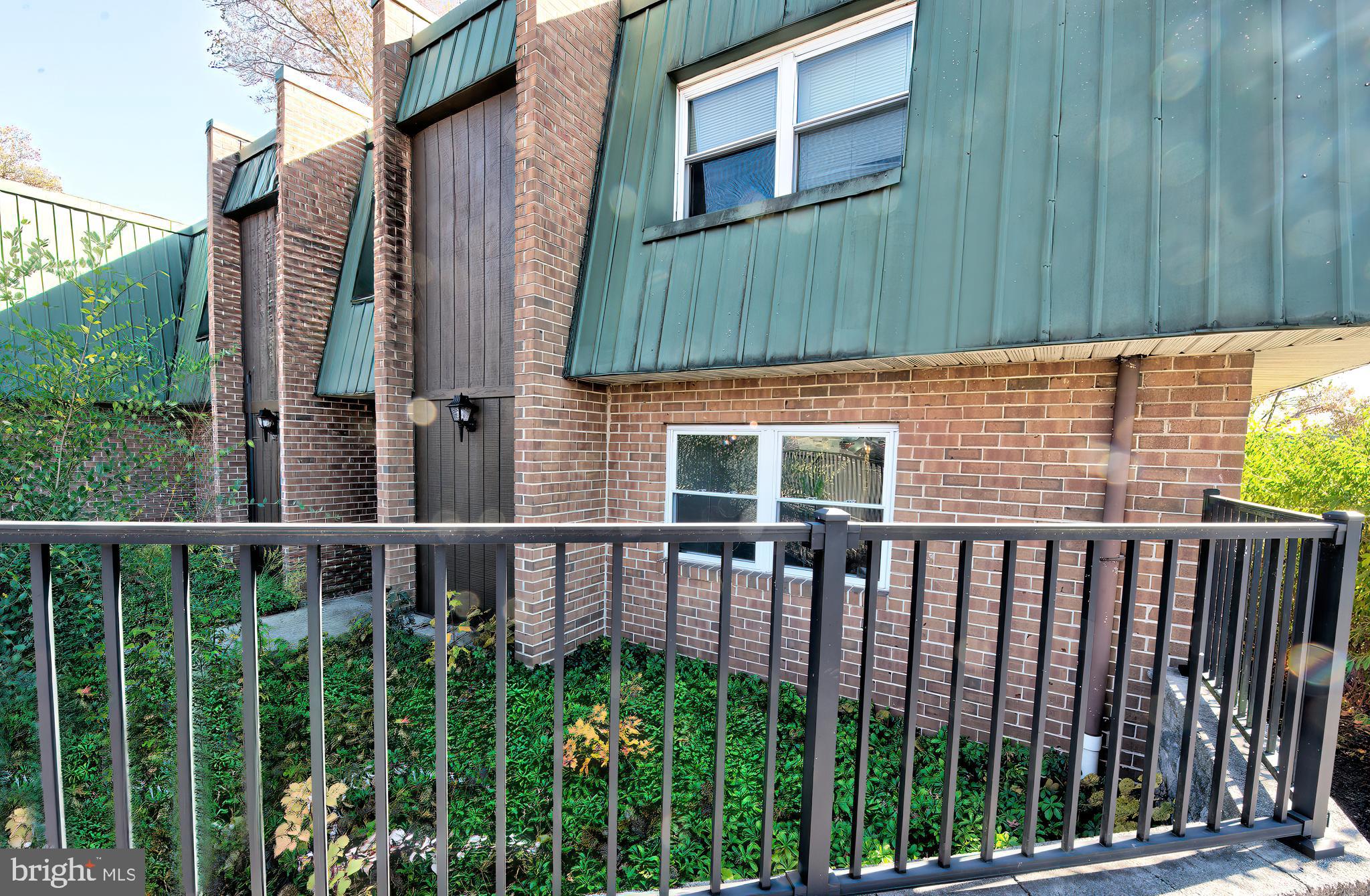 a view of a brick house with a small yard