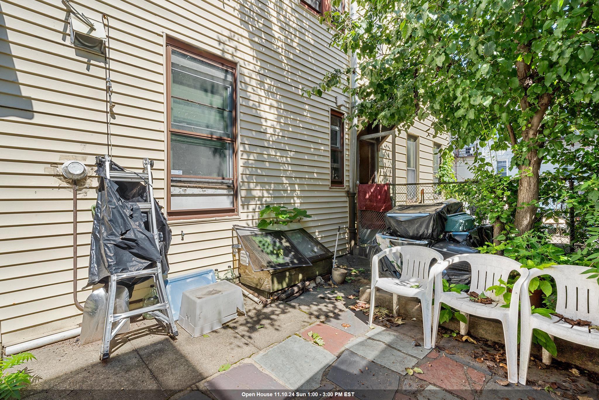 a view of a patio with table and chairs and potted plants