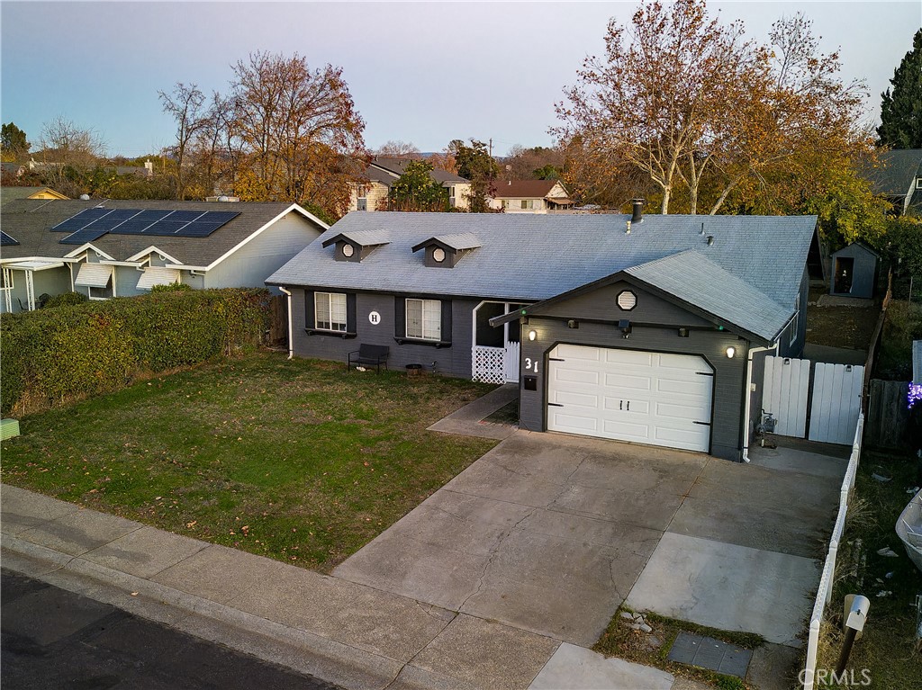 a view of a big house with a big yard and large tree