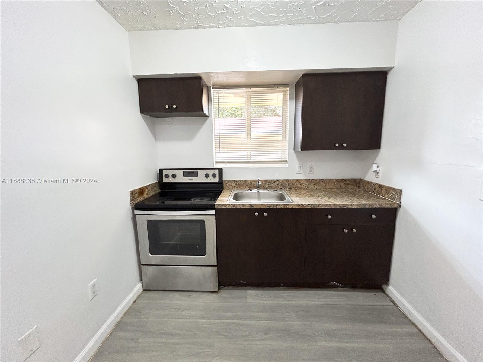 a kitchen with a stove and a microwave