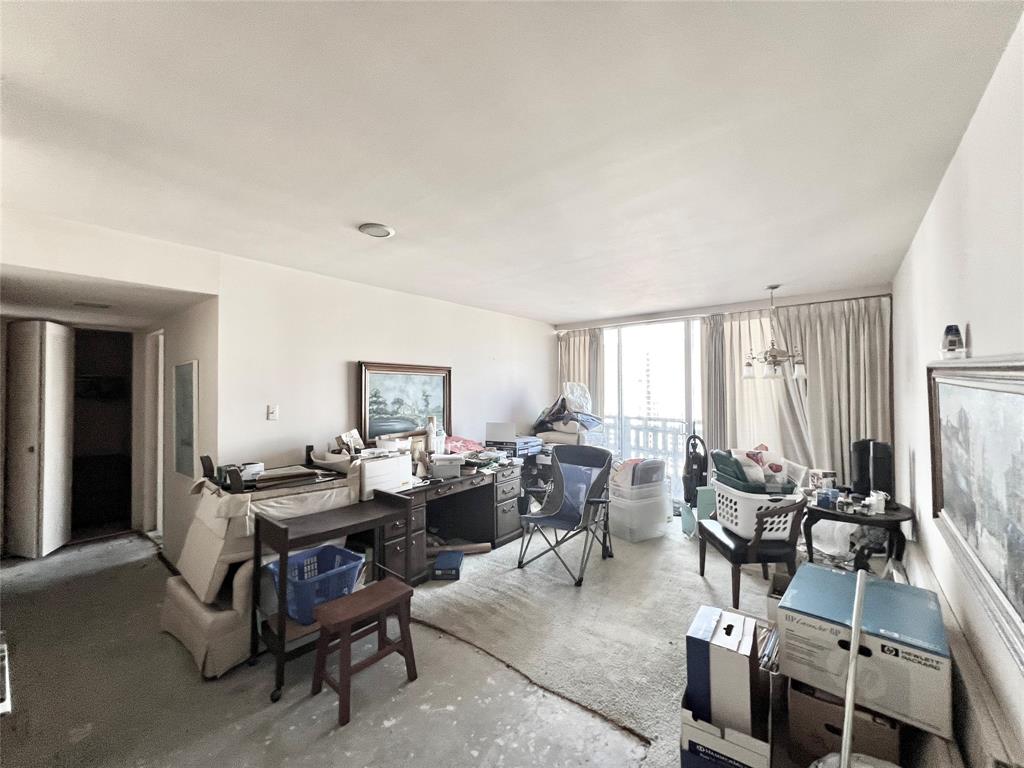 a view of a livingroom with furniture and a window