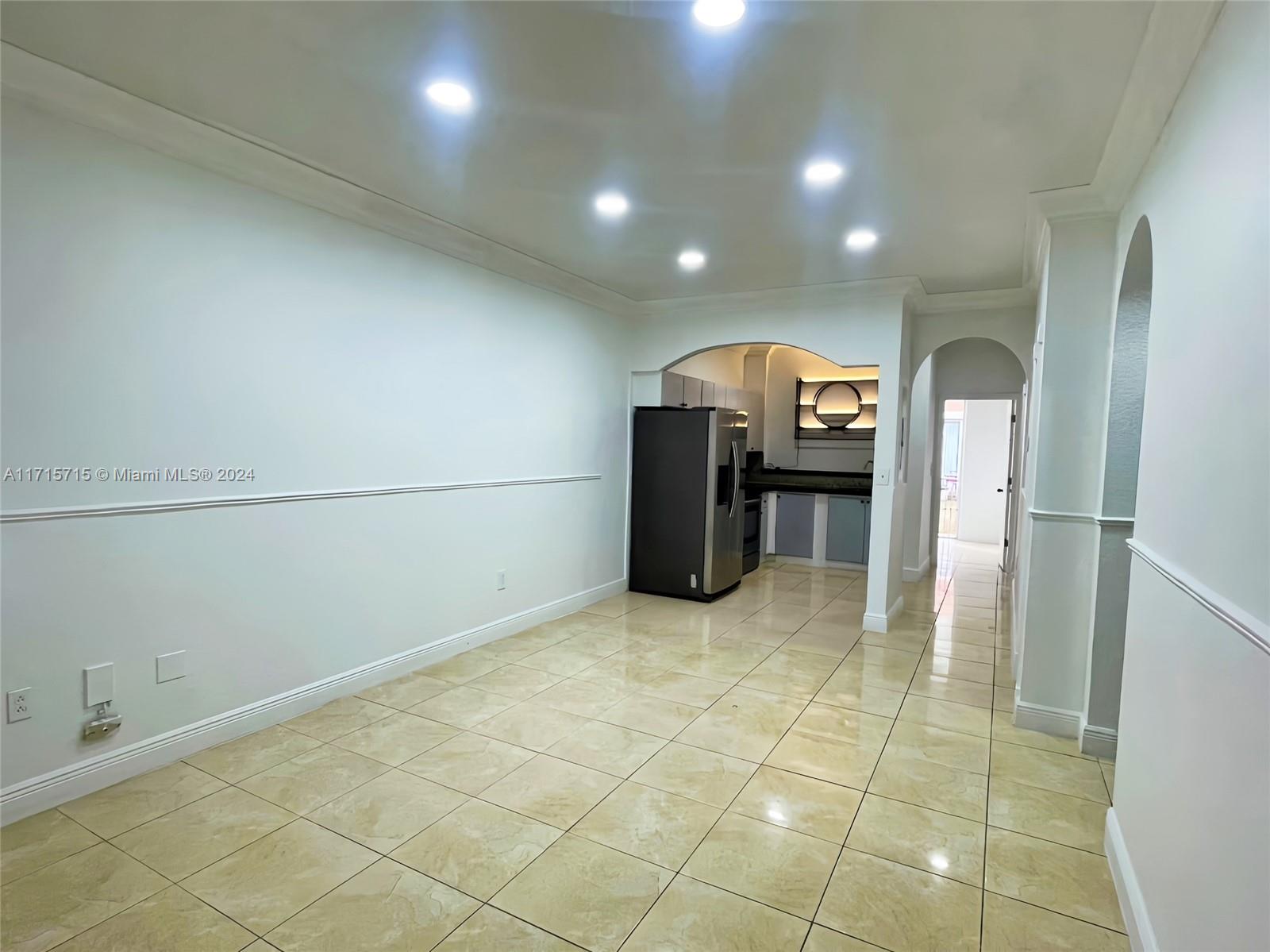 a view of a hallway with a refrigerator