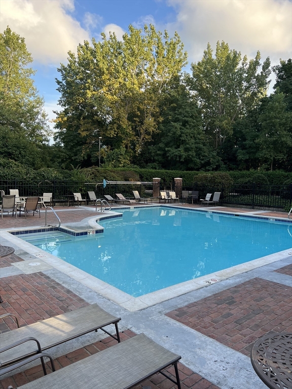 a view of a swimming pool with chairs