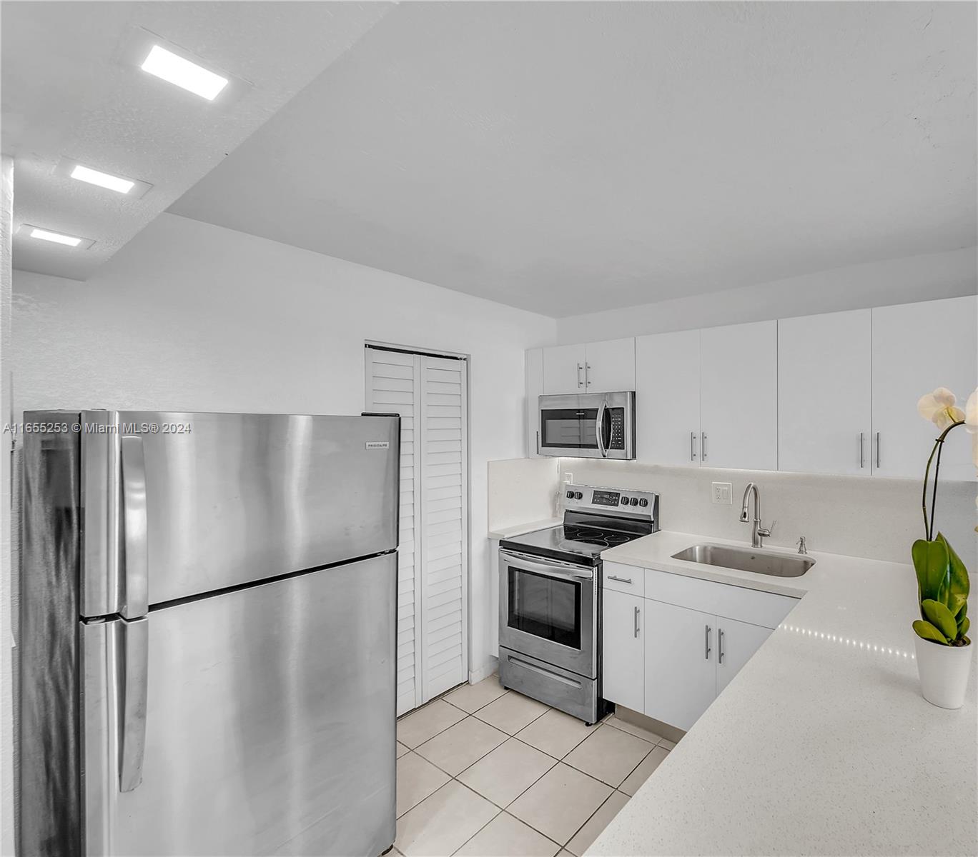 a kitchen with a refrigerator sink and stove