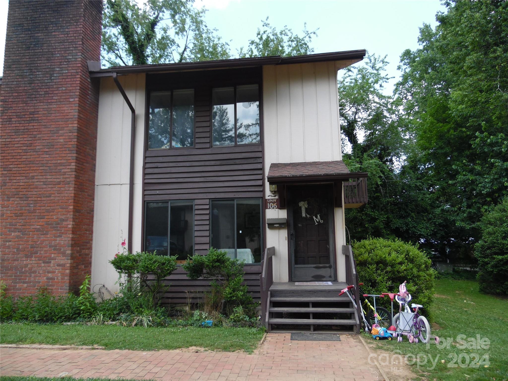 a front view of a house with garden