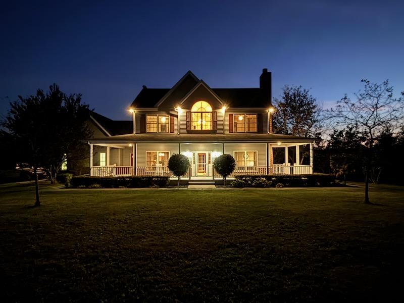 a front view of a house with a garden