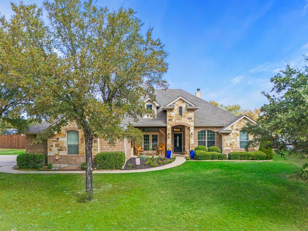 a front view of a house with a yard porch and green space