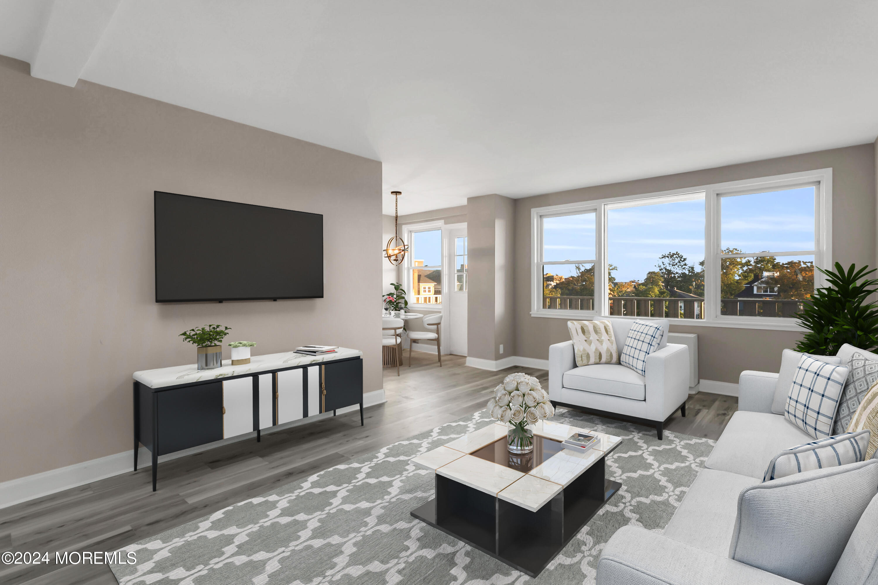 a living room with furniture a rug and a flat screen tv