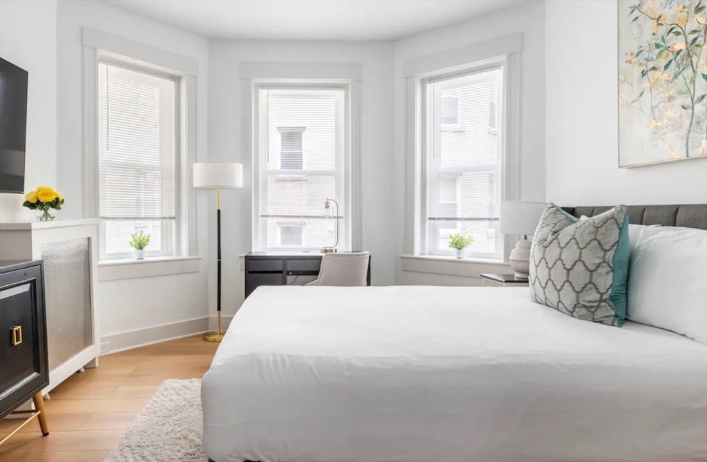 a spacious bedroom with a bed and window