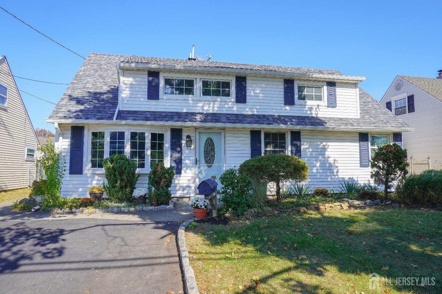 a front view of a house with garden and porch