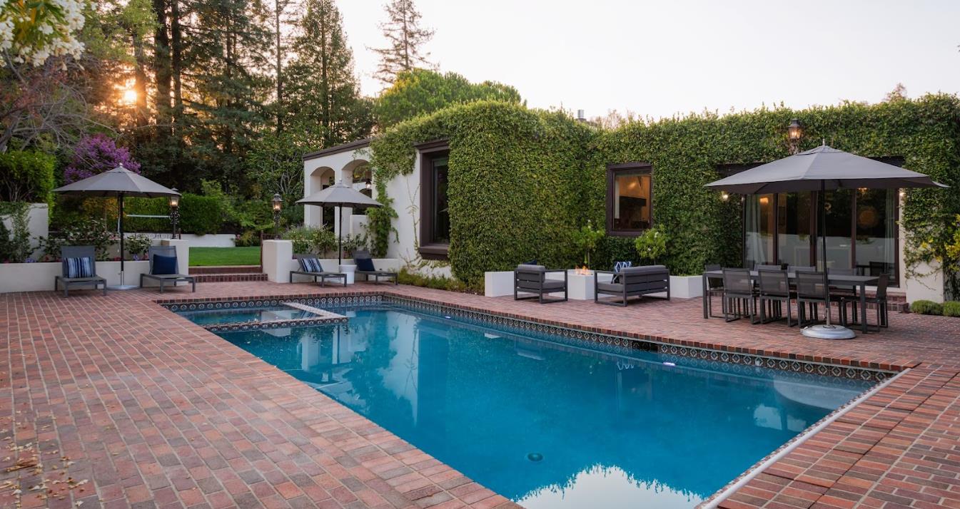 a swimming pool view with a seating space