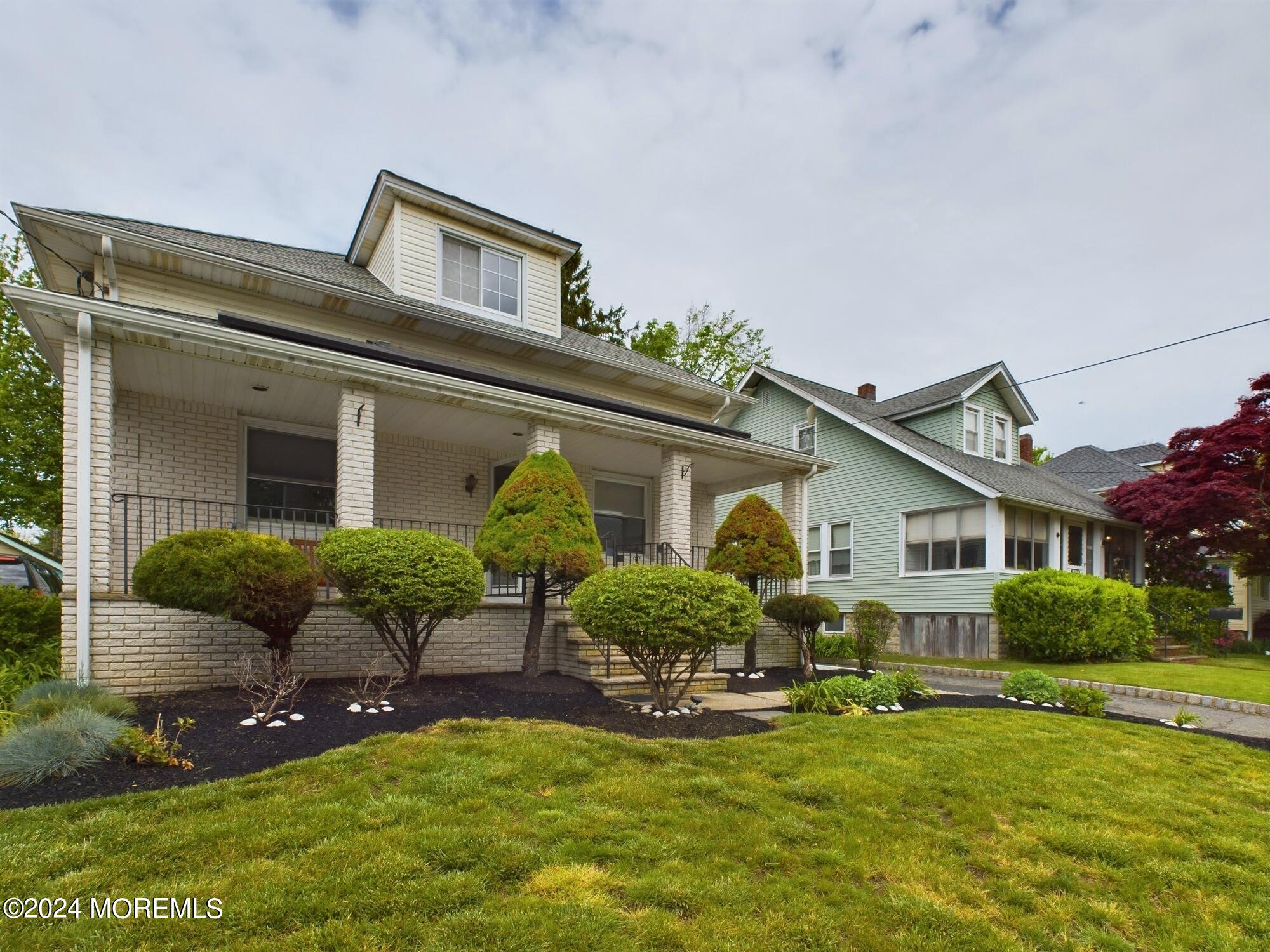 a front view of house with yard and outdoor seating