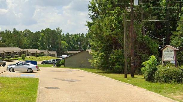 a couple of cars parked in front of a house