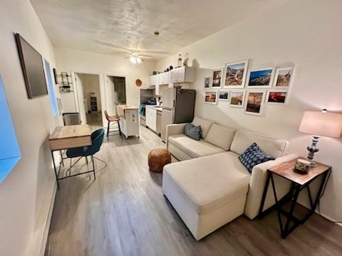 a living room with furniture and wooden floor