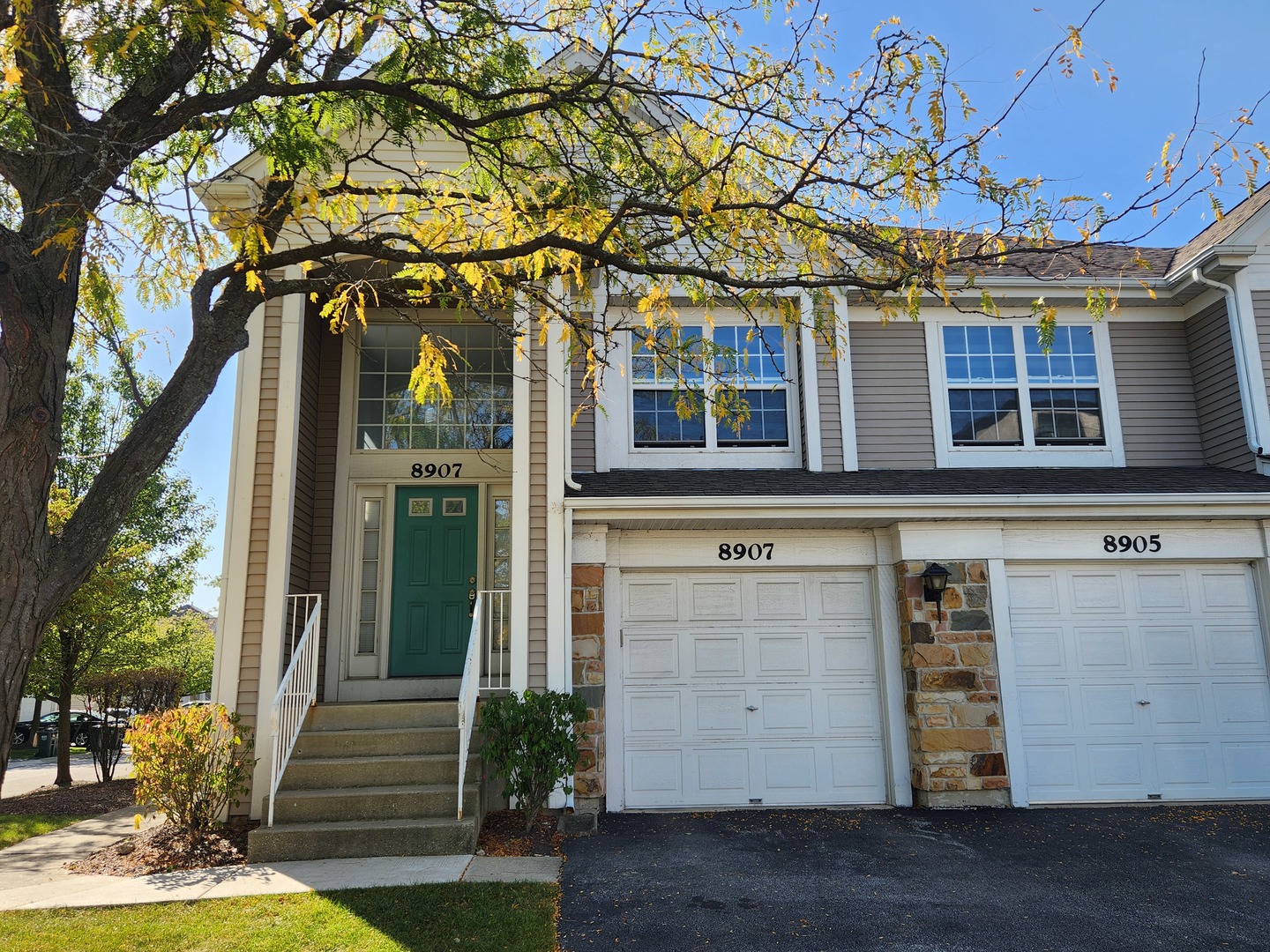 front view of a house with a tree