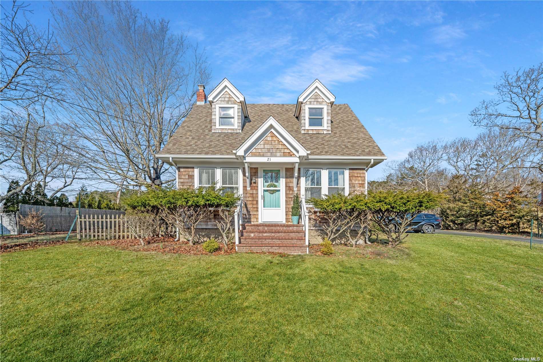 a front view of house with a garden