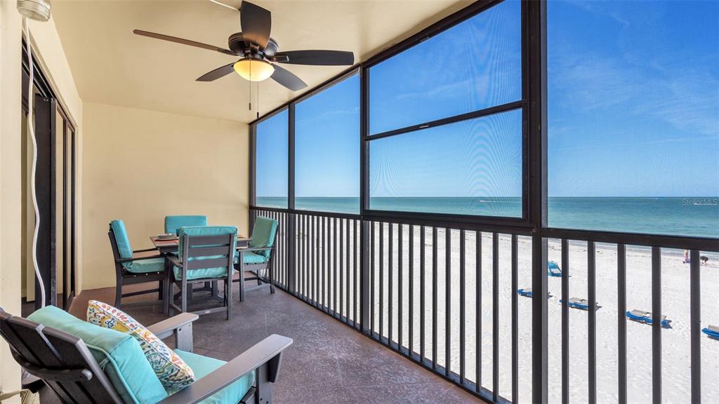 a view of a chairs and table in a balcony