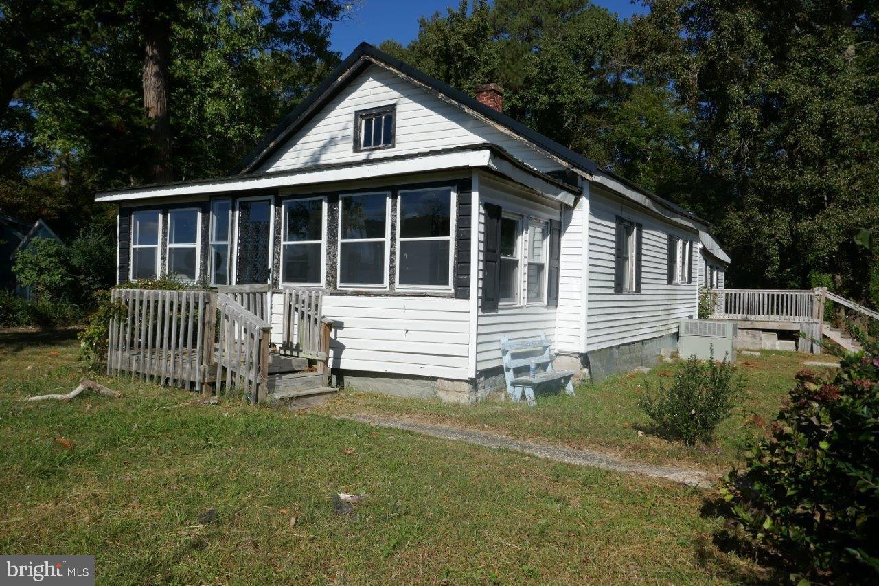 a view of a house with a yard and sitting area